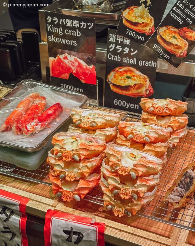 crab shell gratin and king crab skewer stall Nishiki Market Kyoto Japan